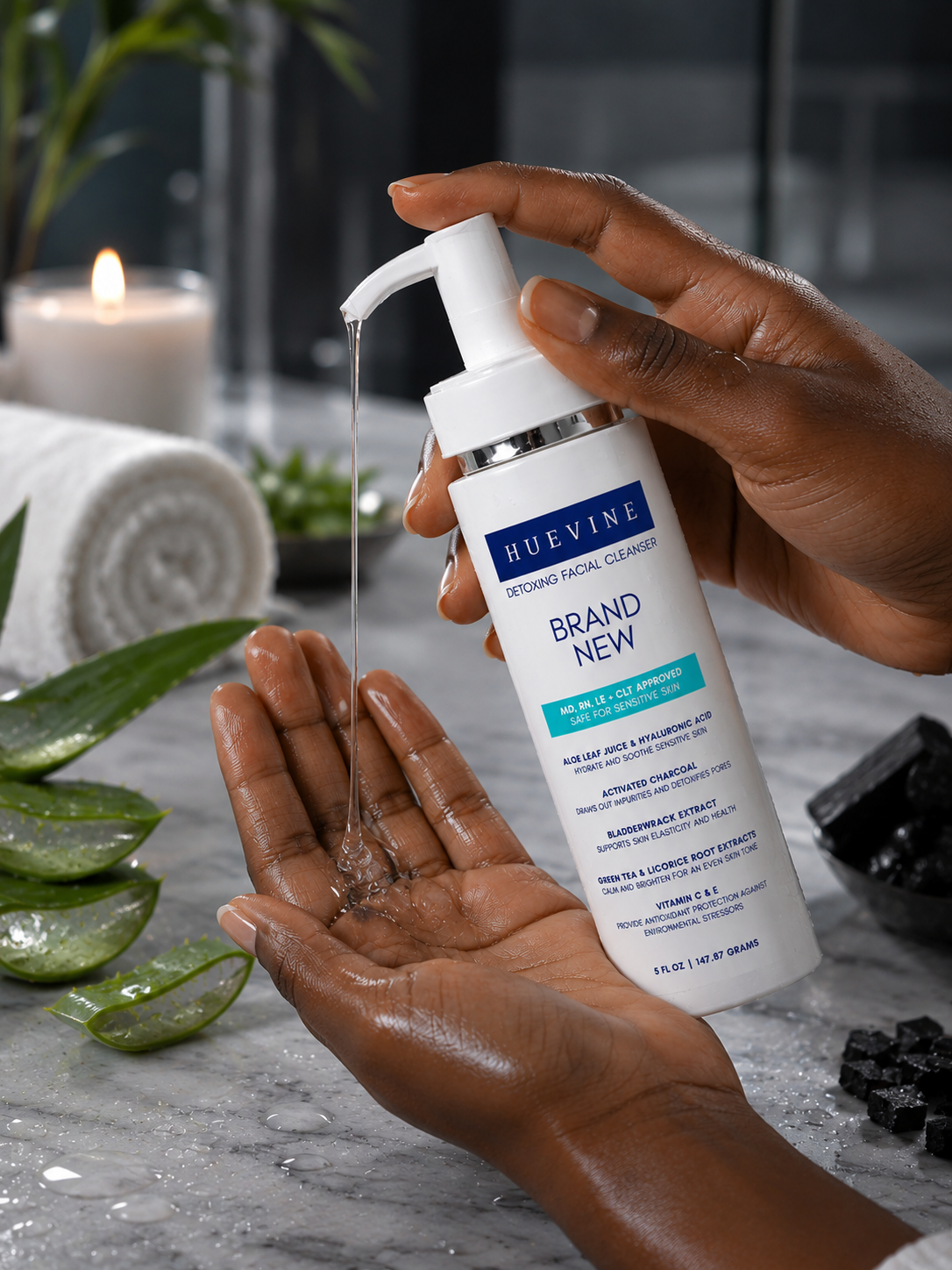Hand dispensing HueVine Brand New Detoxing Facial Cleanser during a skincare routine.