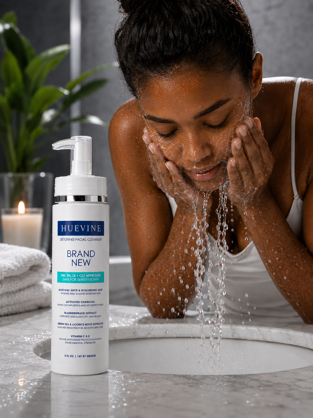 Woman washing her face with HueVine Brand New Detoxing Facial Cleanser during a skincare routine.