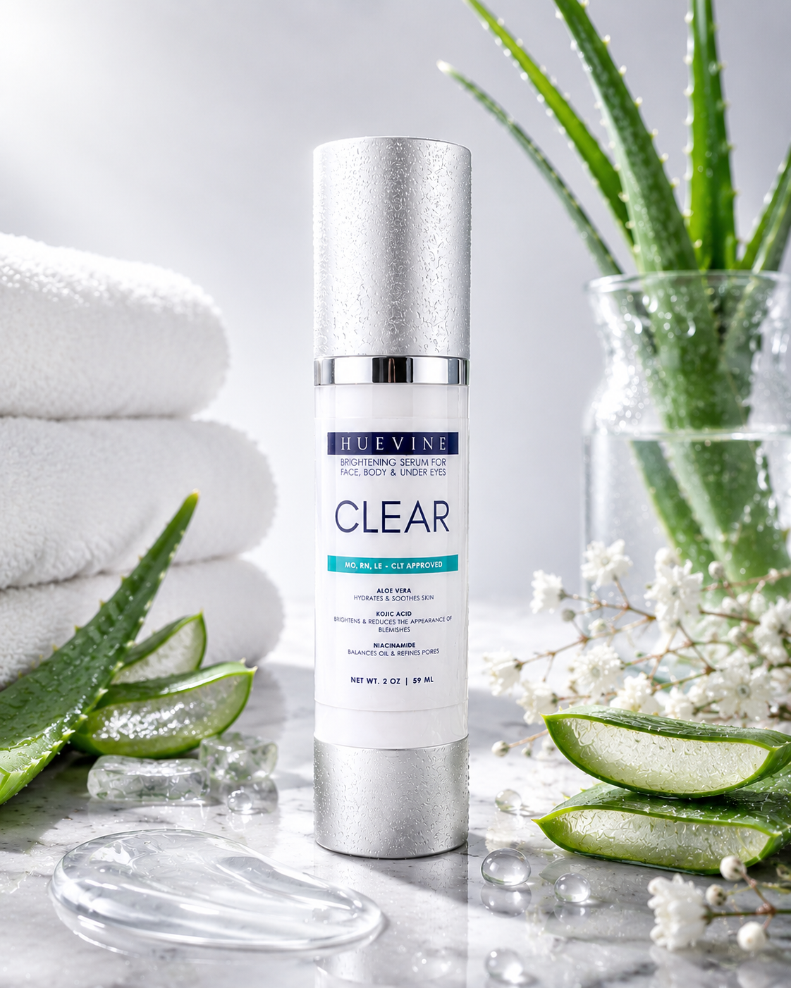 HueVine Clear Brightening Serum displayed with aloe vera, spa towels, and botanical ingredients in a luxury skincare setting.