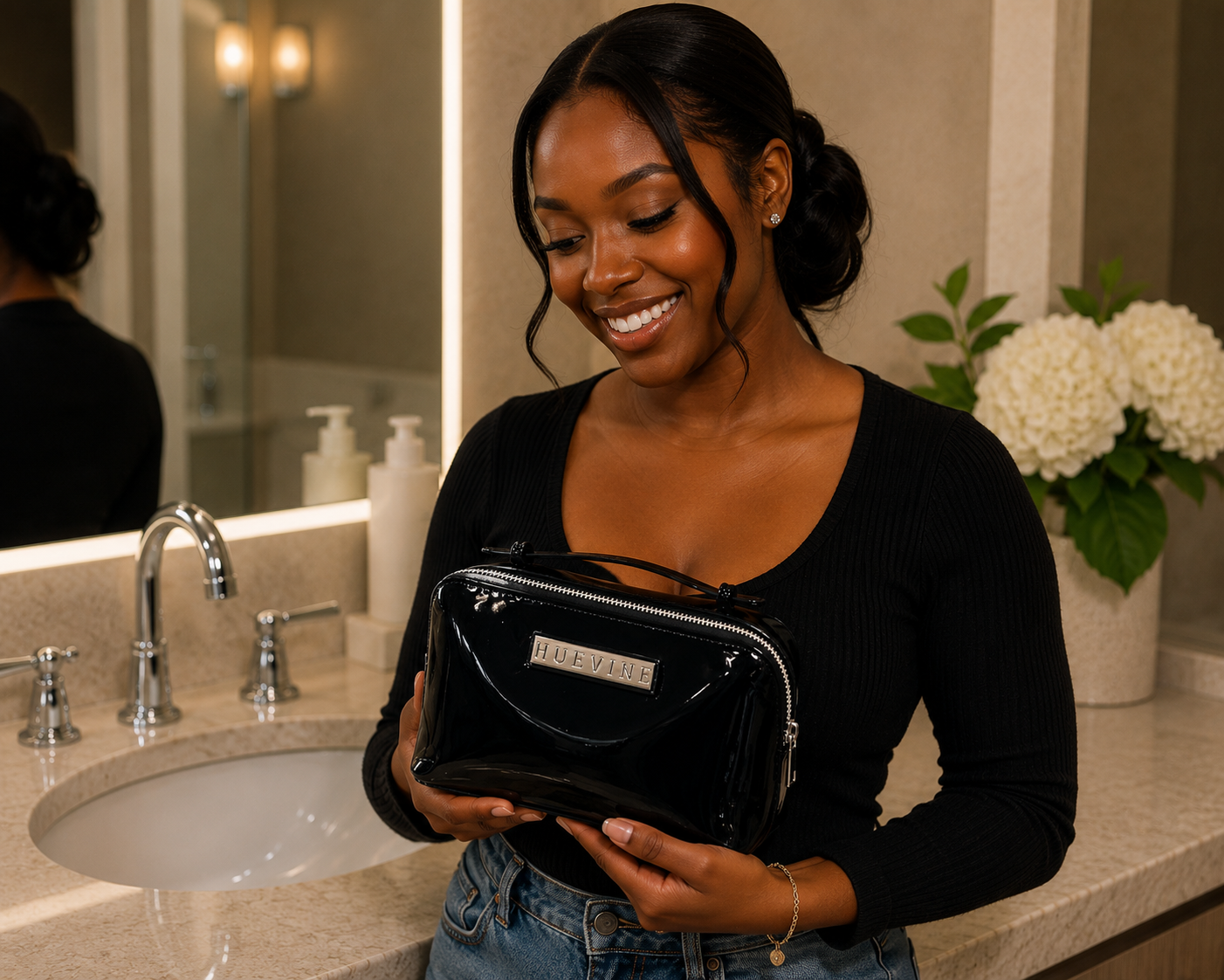 Woman holding the HueVine Glow Bag in a luxury bathroom setting.
