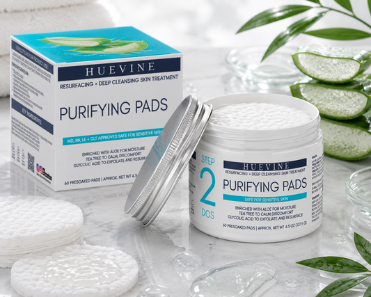 HueVine Purifying Pads resurfacing and deep cleansing skin treatment displayed with open container, retail packaging, and individual cleansing pads in a luxury skincare setting.