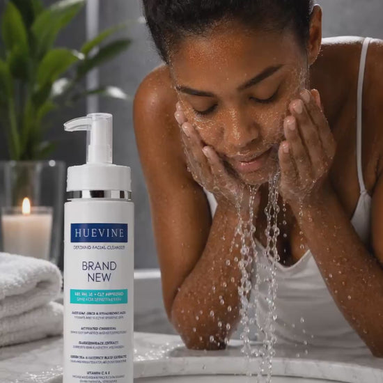 Woman washing her face with HueVine Brand New Detoxing Facial Cleanser during a skincare routine.
