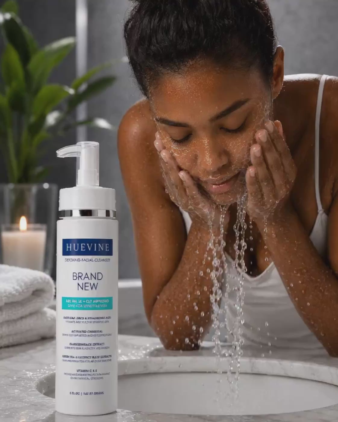 Woman washing her face with HueVine Brand New Detoxing Facial Cleanser during a skincare routine.