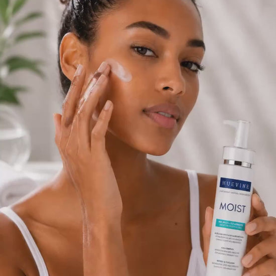 Person demonstrating application of HueVine MOIST lightweight AHA gel moisturizer as part of a facial skincare routine.